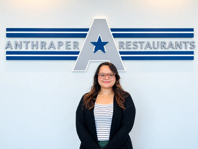 Nancy Bacy standing in front of the Anthraper Restaurants office sign
